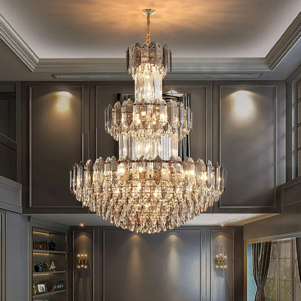 The Lazzo Modern Chandelier by Morsale graces a luxurious room with dark walls and bookshelves. Its grand, contemporary design showcases crystal shades and a multi-tiered arrangement of angular prisms illuminated by LED bulbs, casting a warm light that enhances the elegant and opulent ambiance.