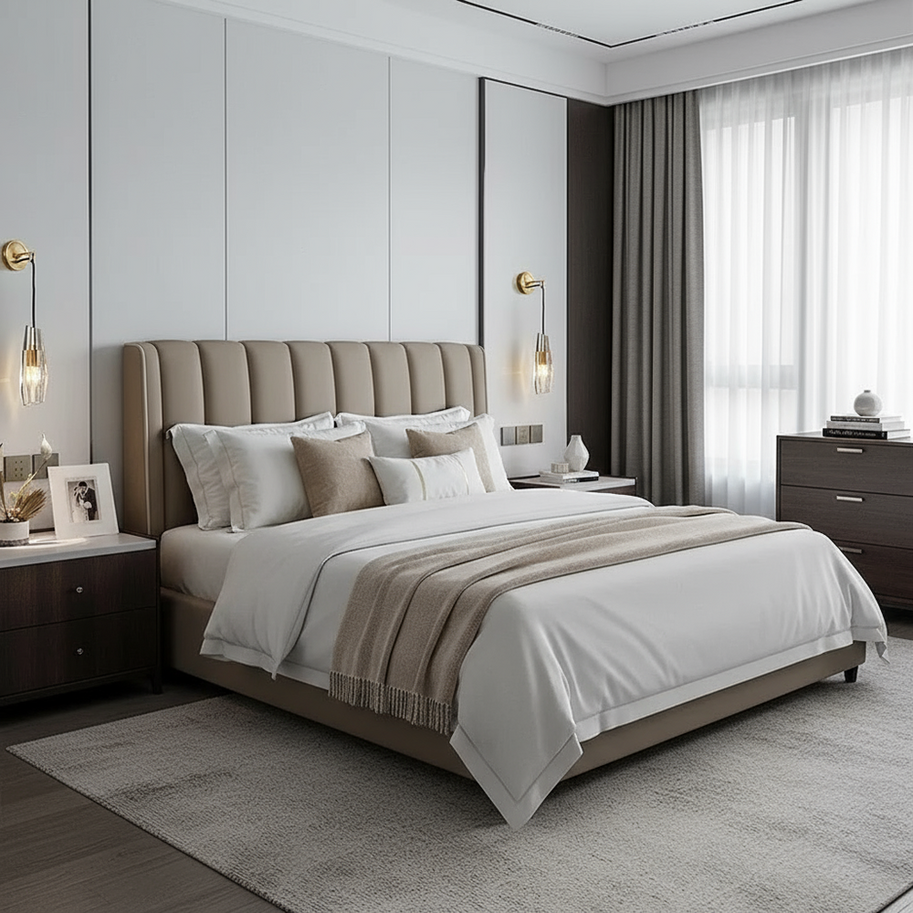 A modern bed with neutral bedding and a beige upholstered headboard is flanked by dark wood nightstands. The serene bedroom features the Morsale Barrow Crystal Wall Sconce, framed photos, and a large window with sheer curtains.