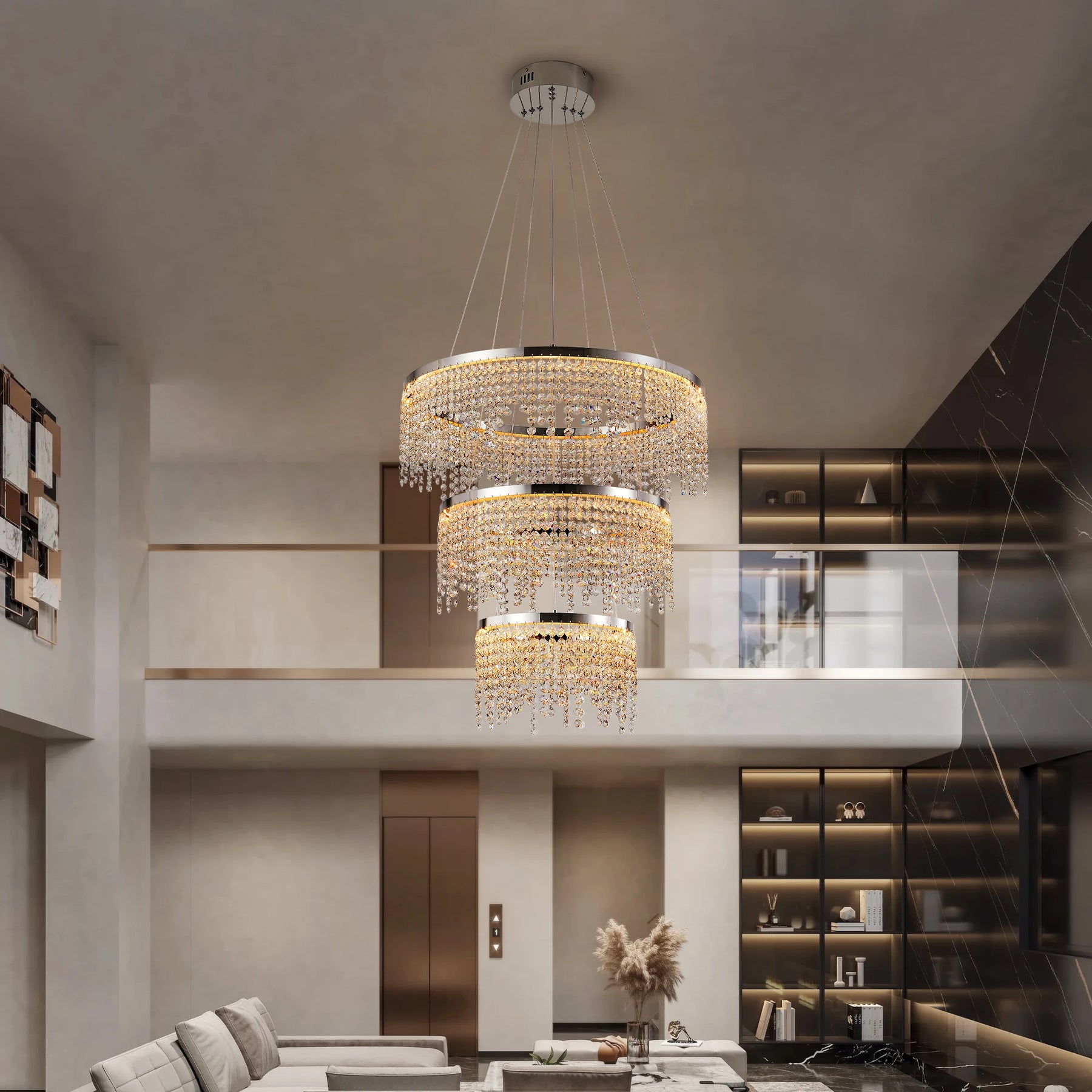 A modern living room with high ceilings showcases the Morsale Alleri 3-Tier Crystal Chandelier, alongside sleek pendant lights. The space is adorned with a neutral palette, a comfortable sofa, and built-in shelving, all overlooked by a glass balcony.