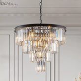 Morsale's 23.6" Gio Crystal Chandelier features a tiered design and sparkling glass prisms, casting a warm glow to create a luxurious atmosphere in any ornately molded room.