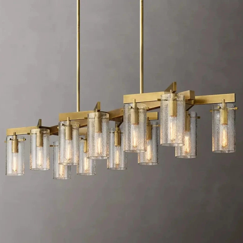 The Leroi Brass Dining Room Chandelier by Morsale features a modern design with a gold rectangular frame that suspends multiple cylindrical textured glass shades, each containing a light bulb. The elegant design of the shades and versatile lighting options make it perfect for any brass dining room chandelier setup. It hangs from two gold rods attached to the ceiling, adding sophistication to your space.