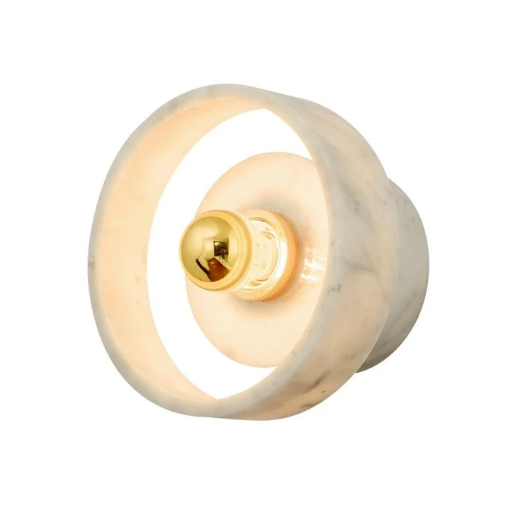 The Menards Modern Marble Wall Lamp by Morsale is a wall-mounted light fixture with a modern, minimalist design. It features a white marble circular frame surrounding a central brass light bulb holder, emitting a warm glow. The LED bulbs are visible, adding to the fixture's contemporary aesthetic.