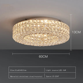 The Bacci Crystal Ceiling Light Fixture by Morsale, featuring LED bulbs, is elegantly installed on the ceiling, casting a warm glow. The illumination dances off the crystals, producing a sparkling effect. The room boasts modern decor with dark walls and offers a view of the dining area below.