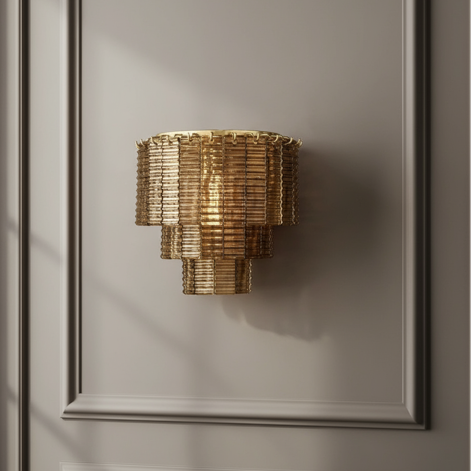 The Palermo Stained Glass Sconce from Chandelier Style features layered glass panels and is mounted on a gray paneled wall, casting subtle shadows and bringing an elegant, modern accent to the decor.