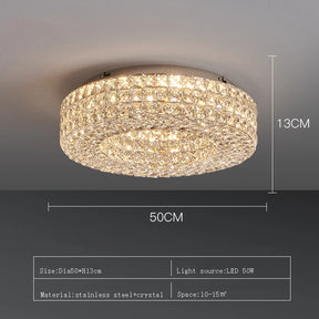 The Bacci Crystal Ceiling Light Fixture by Morsale, featuring LED bulbs, is elegantly installed on the ceiling, casting a warm glow. The illumination dances off the crystals, producing a sparkling effect. The room boasts modern decor with dark walls and offers a view of the dining area below.