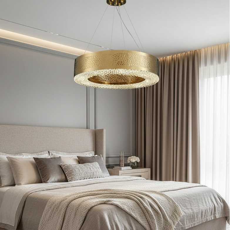 A modern bedroom features a beige bed, neutral bedding, soft beige curtains, and a nightstand with flowers. The Morsale Alleri Modern Chandelier is the centerpiece, adding luxury and elegance to this calm, cozy space.