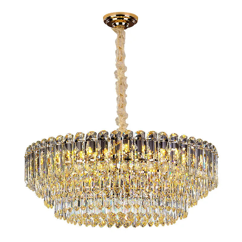 The Morsale Gio Crystal Chandelier is a luxurious lighting fixture featuring multiple tiers of hanging crystals and a gold-colored design. This modern chandelier is equipped with LED bulbs to emit a warm, elegant glow and is elegantly suspended from a gold ceiling mount.