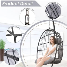 A woman sits in a black Morsale Patio Wicker Hanging Egg Chair with grey cushions, smiling. The chair includes a strong suspension hook, slip-resistant cushions, an enhanced X-shape design, and is crafted from weather-resistant rattan for enduring quality.