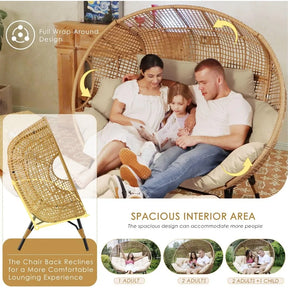 A family of three enjoys the spacious, semicircular Winsford Patio Lounge Chair by Morsale, featuring a modern rattan design with cushioned seating and a reclining back. Ideal for beach trips or backyard gatherings, this versatile piece comfortably accommodates two adults and a child.