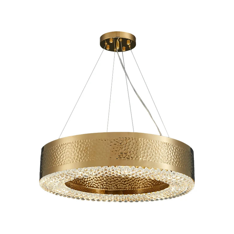 The Alleri Hammered Gold & Crystal Chandelier by Morsale is a luxurious round fixture hanging from the ceiling by three wires. Its textured gold finish is beautifully complemented by LED bulbs and a bottom edge lined with crystals, producing a sparkling effect that captures modern style.