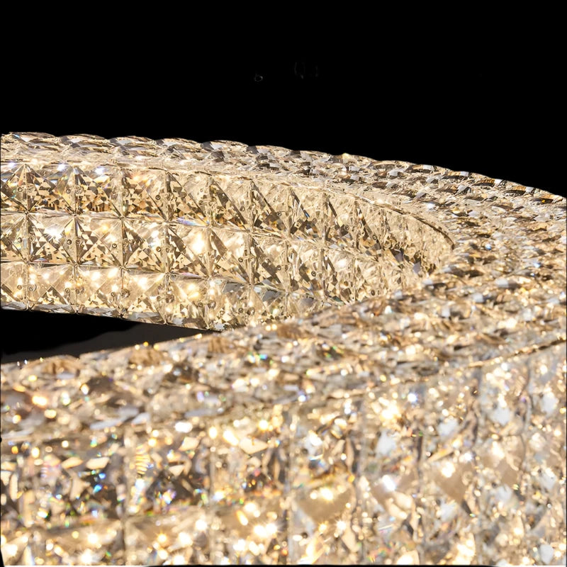 Close-up of the Bacci Crystal Ceiling Light Fixture by Morsale, featuring a circular design crafted from high-quality crystal, ideal for modern style interiors. The intricately arranged crystals reflect light beautifully, creating a dazzling effect. Illuminated by LED bulbs, "High Quality Crystal" shimmers at the top of the image.