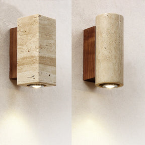 The Natural Travertine Wall Lights from Morsale.com feature a wall-mounted light fixture with a rectangular, stone-like cover and a wooden mounting base. The LED wall lamp directs light downward, casting a soft glow on the gray wall below, embodying Japan-style lighting aesthetics.