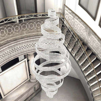 The Alleri Crystal Foyer Chandelier by Morsale.com spirals gracefully above the grand staircase, its modern design crafted from countless crystals. Ornate railings and classical architecture enhance the ambiance of sophistication and elegance.
