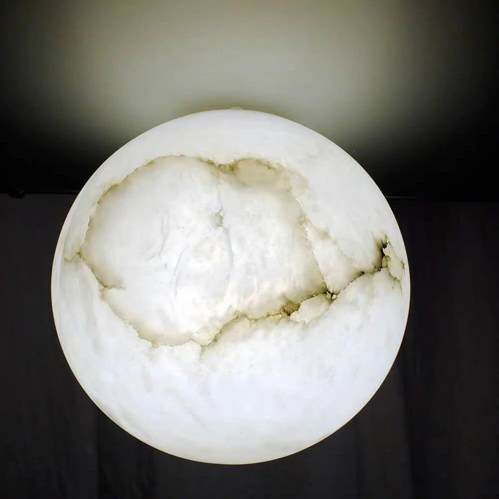 The Moonshade Marble Ball Light Fixture by Morsale captures modern style with its moon-like, marbled design and soft white glow against a dark background.