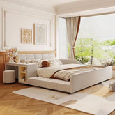 A cozy bedroom showcases the Morsale Chenille Queen Size Bed with neutral-toned bedding, paired with a bedside desk for decor. Large windows invite natural light, framed by soft curtains revealing greenery. Decorative art enhances the cream-colored walls.