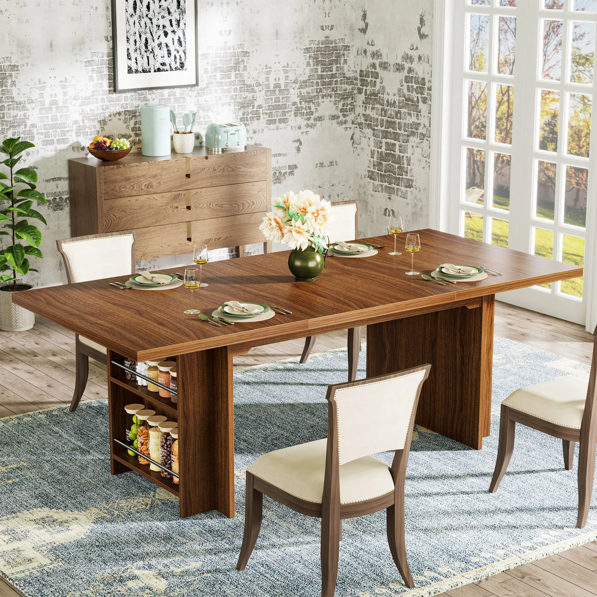 A dining room features the Bristol 63" Dining Table with Storage by Morsale, crafted from vintage brown wood and set for four with plates and glassware. A flower vase sits at its center. Four cream chairs surround it, alongside a sideboard and plant by a large window against textured walls.