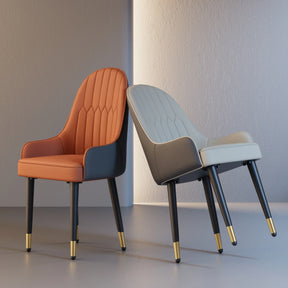 Positioned on a gray floor, the Morsale Vegan Leather Dining Chair set features two stylish chairs with black legs and gold accents. One is vibrant orange with a high back, while the other is light gray, both slightly angled toward each other in a minimalist setting, highlighting ergonomic seating excellence.