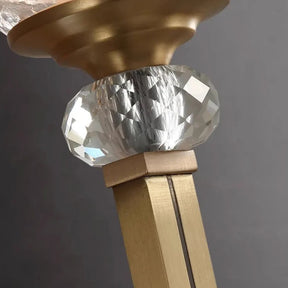 Close-up of the Palermo Copper & Glass Contemporary Wall Sconce by Morsale, showcasing a decorative metallic rod with a faceted glass orb. The orb exudes elegance akin to wall lamps and is positioned between a wide copper base at the top and a square metallic post, reflecting light at various angles against a gray background.