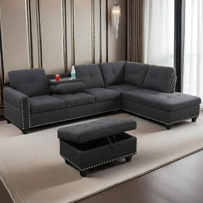 In a contemporary living room, the Morsale Sectional Sofa With Ottoman features stylish gray linen fabric, nailhead trim, and an L-shape with a flip-up console and cup holders. The storage ottoman complements the space surrounded by paneled walls, a large window, and a hanging light fixture.