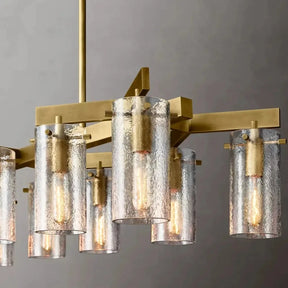 The Leroi Brass Dining Room Chandelier by Morsale features a modern design with a gold metal frame and multiple textured cylindrical glass lampshades. Each lampshade reveals a visible light bulb, adding to the elegant aesthetic. This versatile lighting fixture is perfect as a centerpiece in your dining room and is suspended from the ceiling against a neutral gray background.