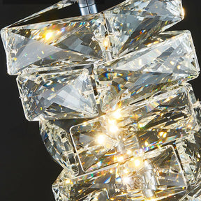 Close-up of a Morsale.com Bacci Crystal Pendant Light Fixture with geometric shaped handmade crystals emitting a warm, bright light, creating sparkles and reflections against a dark background.