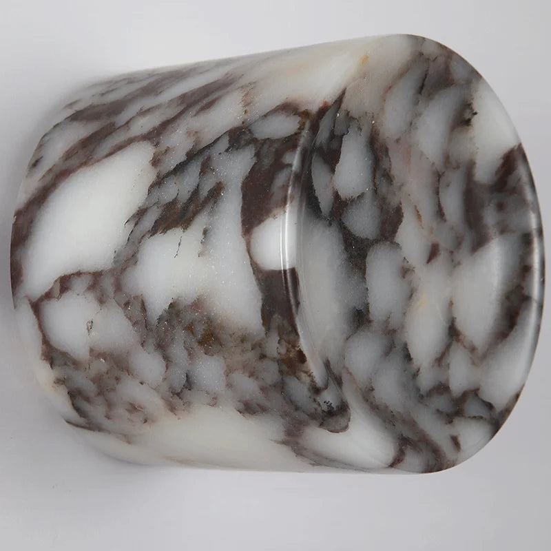 
                  
                    Marbled stone with brown and white patterns on a gray background
                  
                