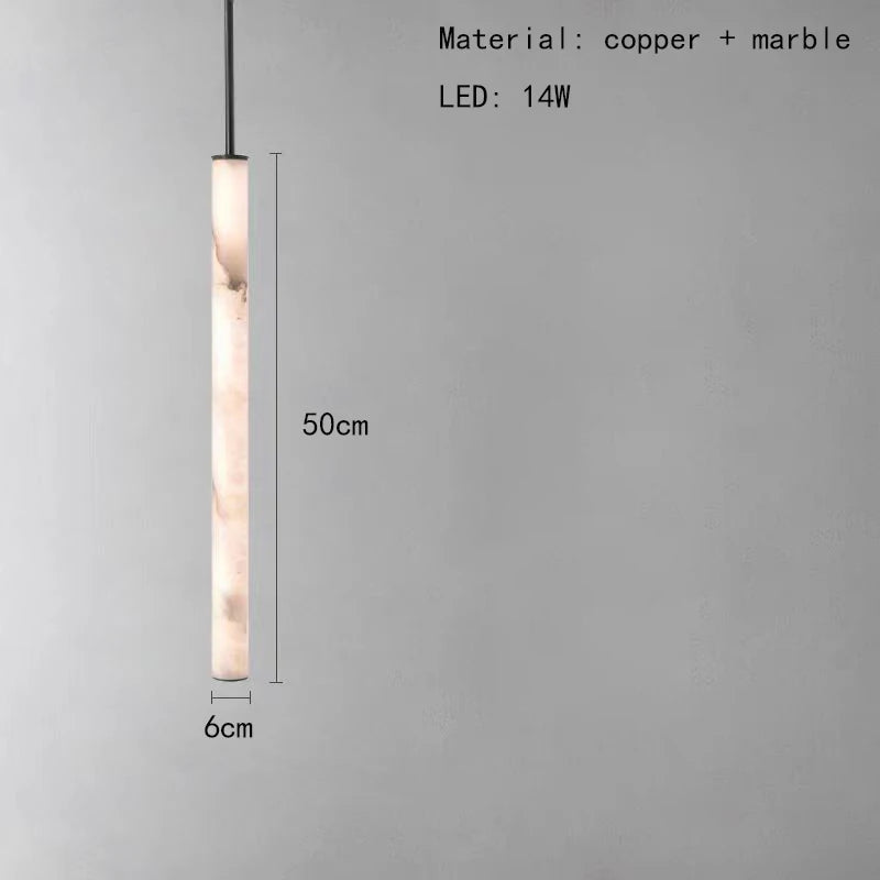 The Natural Marble & Brass Pendant Light Fixture by Morsale.com is a modern cylindrical pendant crafted from natural marble and featuring a polished brass finish. It emits a warm glow and measures 50 cm in height with a 6 cm diameter. The text on the image indicates its LED power is 14W.