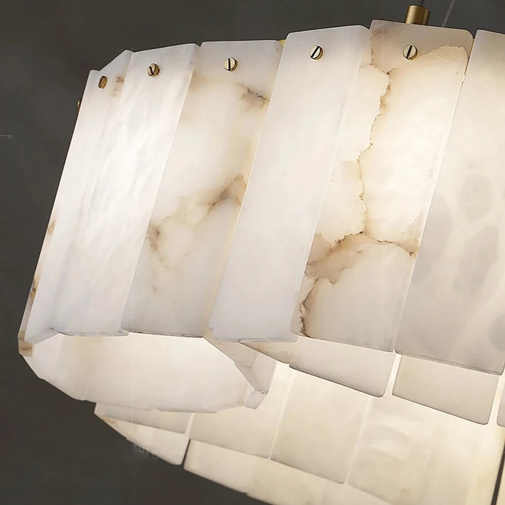 A close-up of a 2-Tier Natural Marble Modern Chandelier by Morsale.com with rectangular, translucent panels. The white panels feature beige marbled patterns and are attached by sleek metallic screws with subtle copper accents. The light glows softly, highlighting the texture and sophisticated design of this natural marble chandelier.