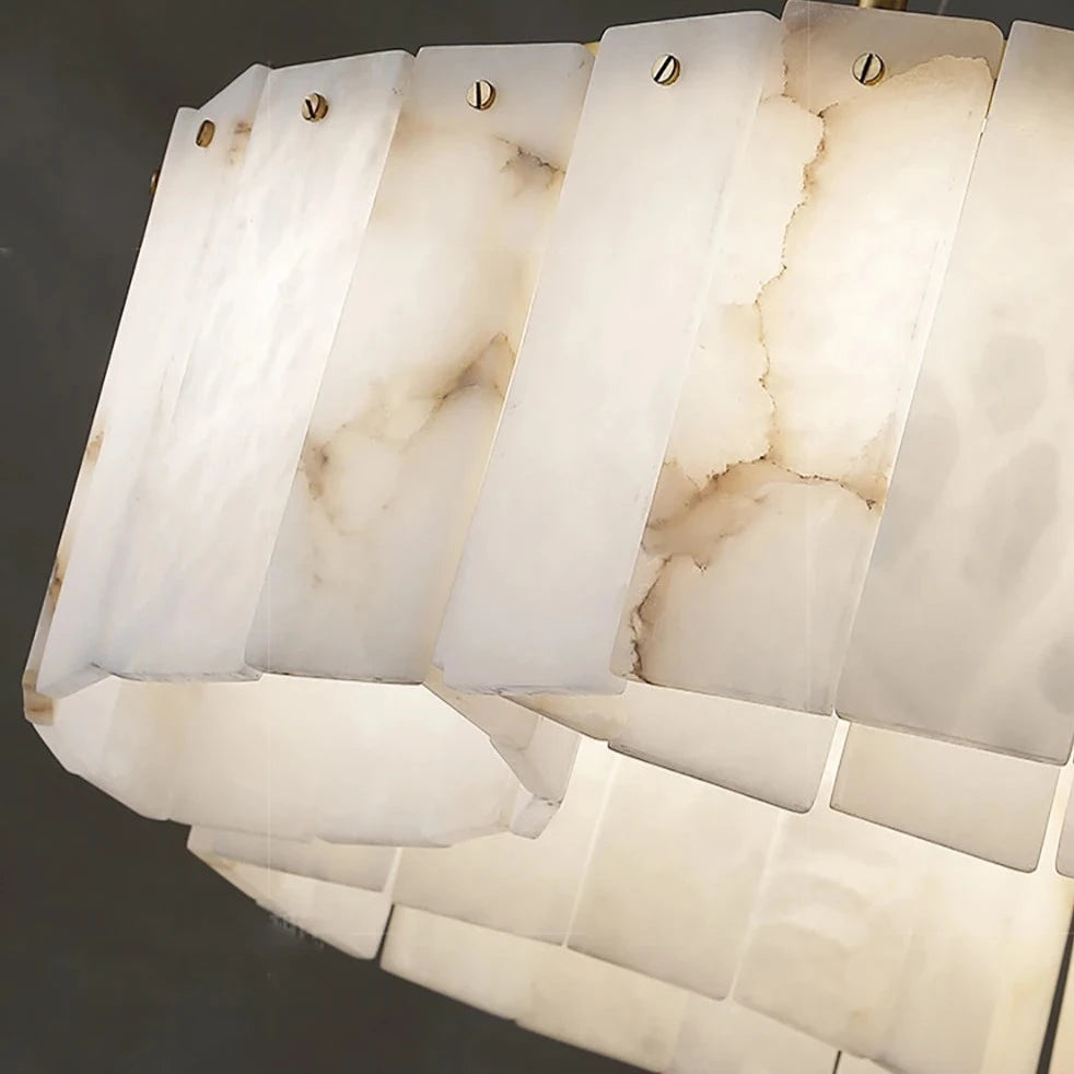 Close-up of the Moonshade Natural Marble Ceiling Light Fixture by Morsale.com with a modern design. The LED light fixture features multiple rectangular, translucent panels with a marbled pattern and brass-colored fasteners, emitting a warm and diffused glow. The background is dark, showcasing the light fixture prominently.
