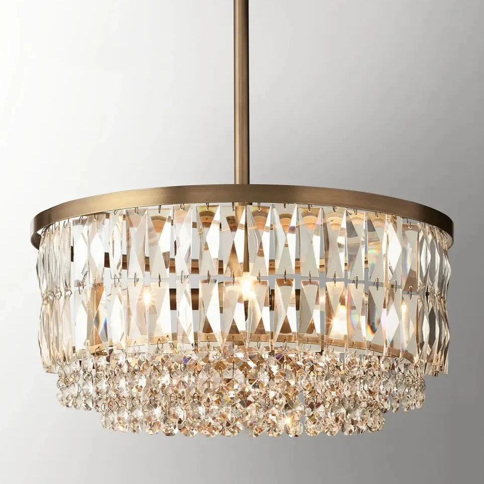 The Bacci Crystal Chandelier from Morsale.com is a luxurious marvel with a metallic gold frame and multiple layers of K9 crystals. These stunning crystals reflect and refract light, creating a mesmerizing sparkle. Suspended from a thin rod attached to the ceiling, it boasts an opulent gold finish.