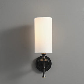 The Morsale American Retro Copper Wall Light showcases a sleek copper material design with a cylindrical white shade and a round black base, elegantly illuminated with LED lighting against a plain gray wall.