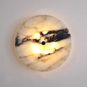 The Morsale Moonshade Natural Marble Sconce Light features Art Deco elegance with a round marble design and central dark button. Its cream base with dark veins houses an LED emitting soft, warm light, perfect for a cozy wall ambiance.