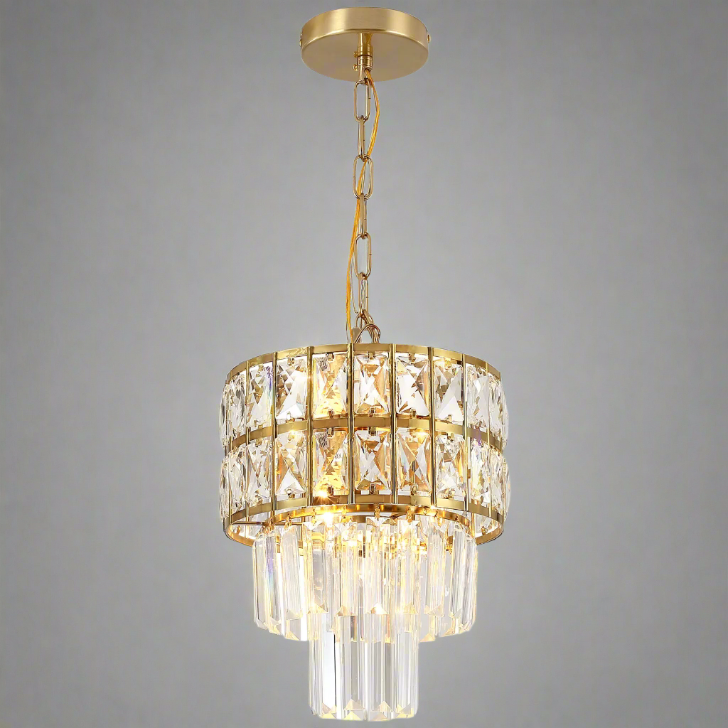 The Gio Crystal Kitchen Pendant Light by Morsale embodies contemporary elegance and timeless design, showcasing two tiers of rectangular and cylindrical crystal prisms. Suspended gracefully from a chain against a plain gray backdrop, it's the ideal chandelier to brighten up any space.