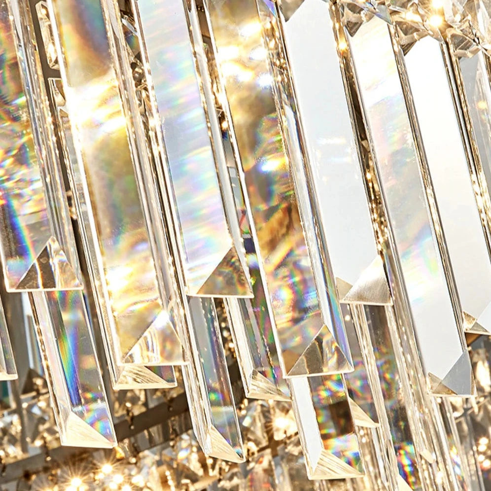 Close-up image of a Gio Flush Mount Crystal Ceiling Light by Morsale.com, showcasing prisms reflecting light in rainbow colors. The hanging handmade clear crystals create a shimmering, dazzling effect, highlighting the intricate details and beautiful light dispersion.