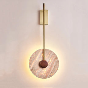 The Moonshade Natural Marble Sconce by Morsale blends Japanese-inspired lighting with a circular stone-like disc and wooden center, softly illuminated from behind. A vertical metal rod gracefully extends from the base to the top, creating a minimalistic design that exudes modern sophistication.