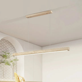 A minimalist, modern cord pendant light fixture from Morsale.com hangs from a high ceiling in a stylish, contemporary room. The Natural Travertine LED Kitchen Light Fixture features a long, rectangular wooden beam with LED bulbs suspended by two thin, nearly invisible cables. The room has clean lines and subtle beige tones.