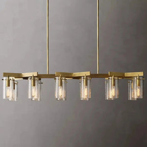 The Leroi Brass Dining Room Chandelier by Morsale is a modern masterpiece featuring a gold-finished design with eight cylindrical glass shades, each housing a light bulb. Suspended from two gold rods, this versatile lighting piece showcases an elegant geometric design against a plain gray background.