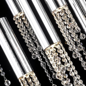Close-up of a Morsale.com Canali Modern Crystal Pendant Chandelier featuring shiny, cylindrical stainless steel fixtures and cascading strands of clear crystals. The black background contrasts with the bright reflective surfaces, accentuating the elegance and intricate details of the lighting design.