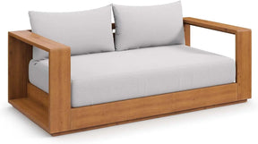 The Tahoe Acacia Wood Outdoor Patio Loveseat by Morsale features light gray cushions on a sturdy wood frame with wide armrests. Easy to assemble, its minimalist design combines natural wood tones and soft neutral fabric for a contemporary US-made style.