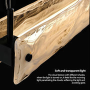 Close-up of the Morsale Costa Dining Room Linear Suspension Chandelier, featuring an elegant, wavy texture. The description reads: "Soft and transparent light." Its modern luxury design offers soft, non-glaring LED illumination akin to morning light through clouds.