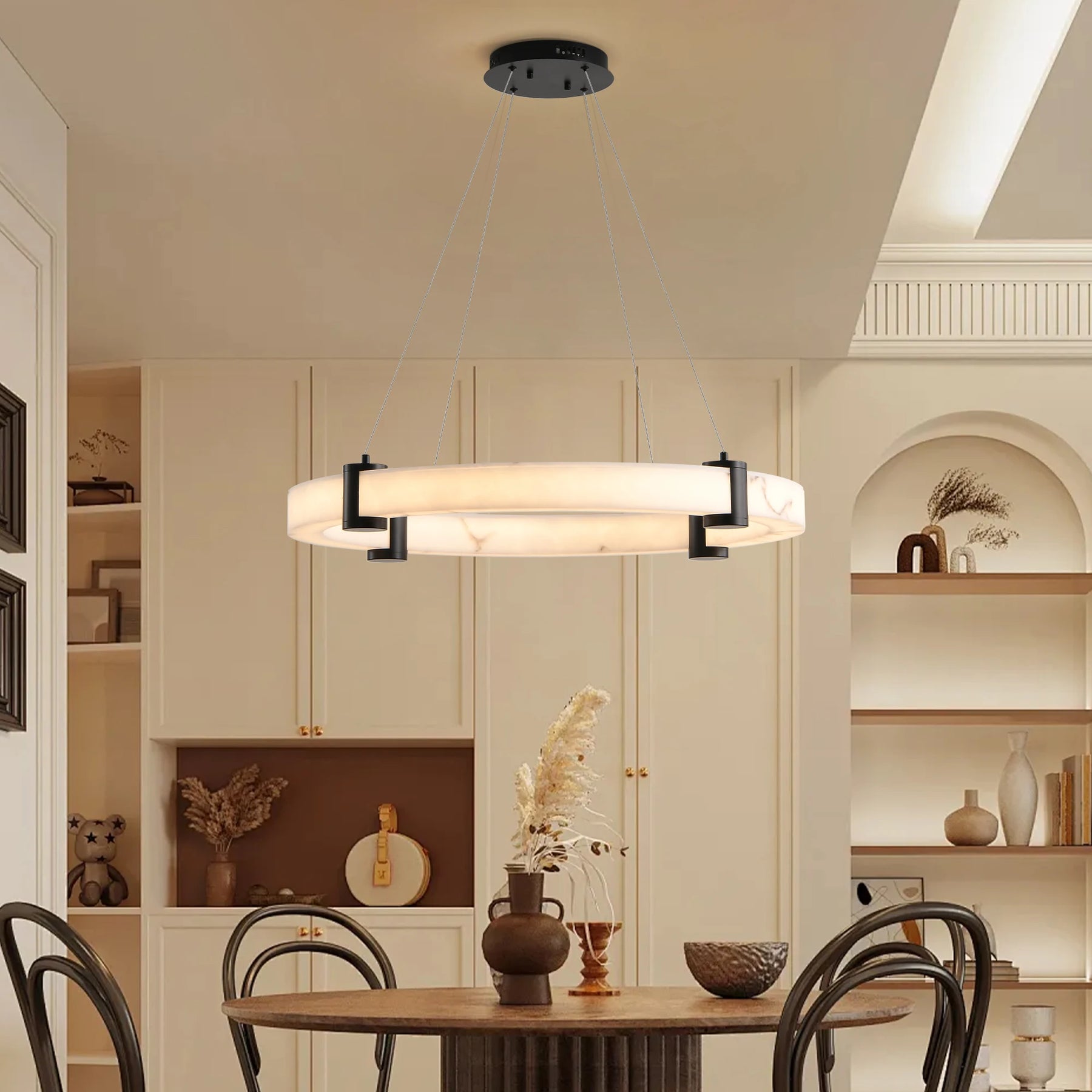 A sleek dining room features the Morsale 23.6" Marble Ceiling Light, casting a glow over a round table and chairs, with shelves of decor and a cabinet in the background for an elegant touch.