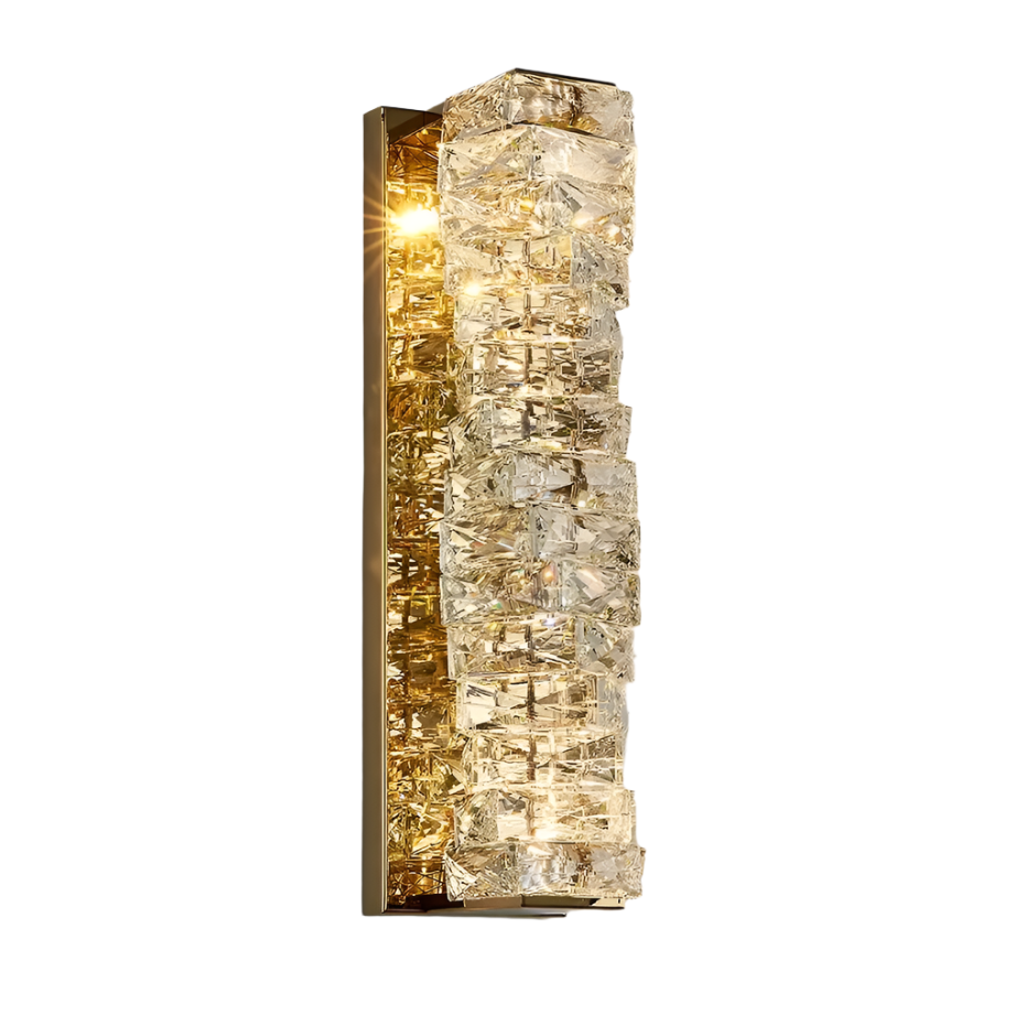 The Morsale.com Bacci Crystal Wall Sconces feature a sleek rectangular design adorned with crystal details that enclose the light, emitting a warm glow. Mounted on a gold-toned brass frame, this contemporary fixture enhances any room with an air of elegance and sophistication.