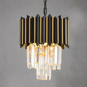 The Morsale Gio Crystal Dining Area Light Fixture features a geometric black frame with cascading crystal prisms and hangs from a chain, emitting a warm LED glow. It enhances the modern ambiance against white walls and framed artwork.