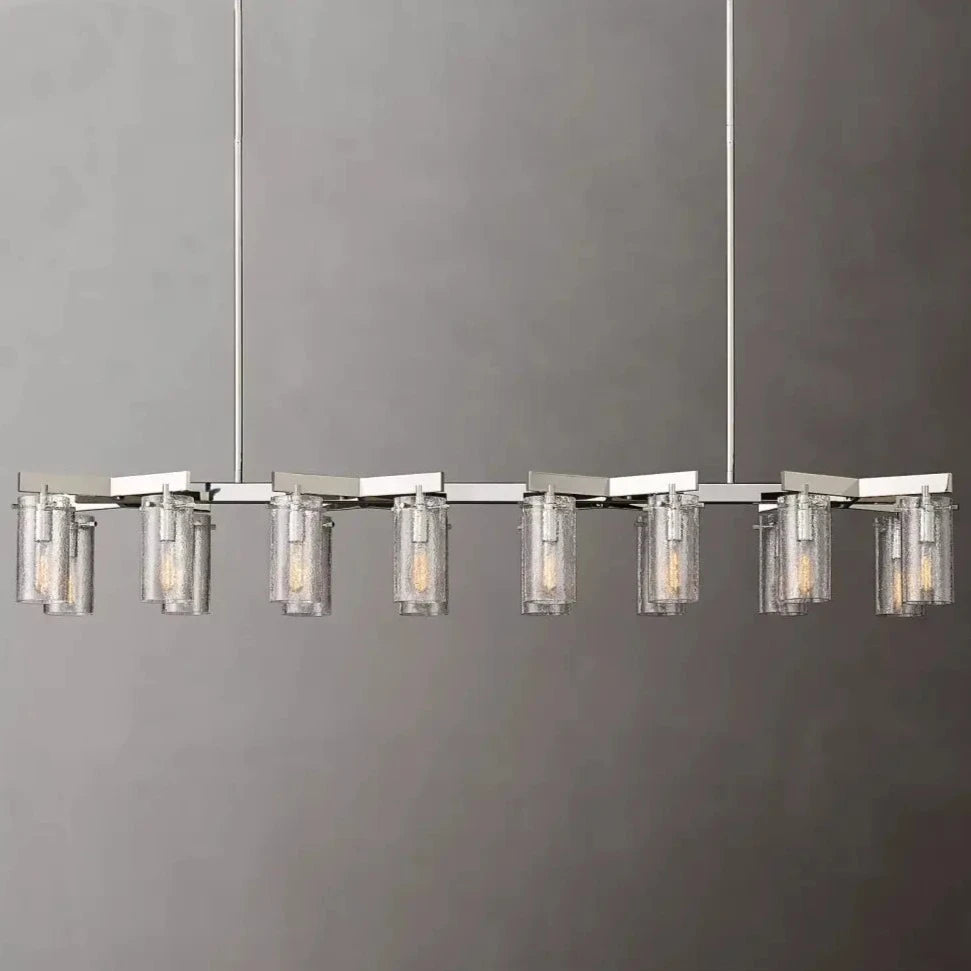 The Leroi Chrome Dining Room Chandelier by Morsale is a modern rectangular fixture with a metallic frame, featuring ten cylindrical glass light fixtures evenly spaced along the length. Each elegant light fixture houses a visible bulb, and the chandelier is suspended by two thin cables against a plain grey background.