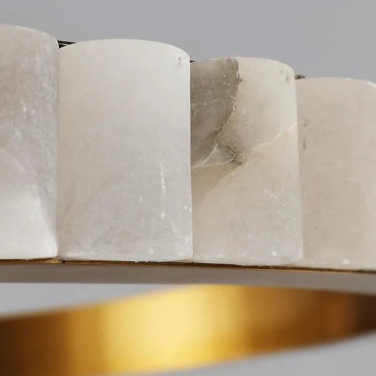 
                  
                    Close-up of a marble-patterned ring with gold base on a gray background
                  
                