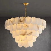 The Bordwell Marble Chandelier by Morsale.com features multiple layers of round, marble-inspired translucent discs hanging from a gold chain and mount, casting a warm, soft glow against a dark gray ceiling.