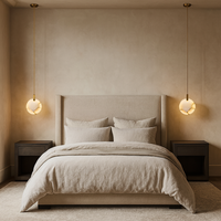 Minimalist bedroom with a beige upholstered bed, matching bedding, two dark wood nightstands, and Morsale.com’s Moonshade Natural Marble Pendant Lights hanging symmetrically on either side against a neutral-toned wall.
