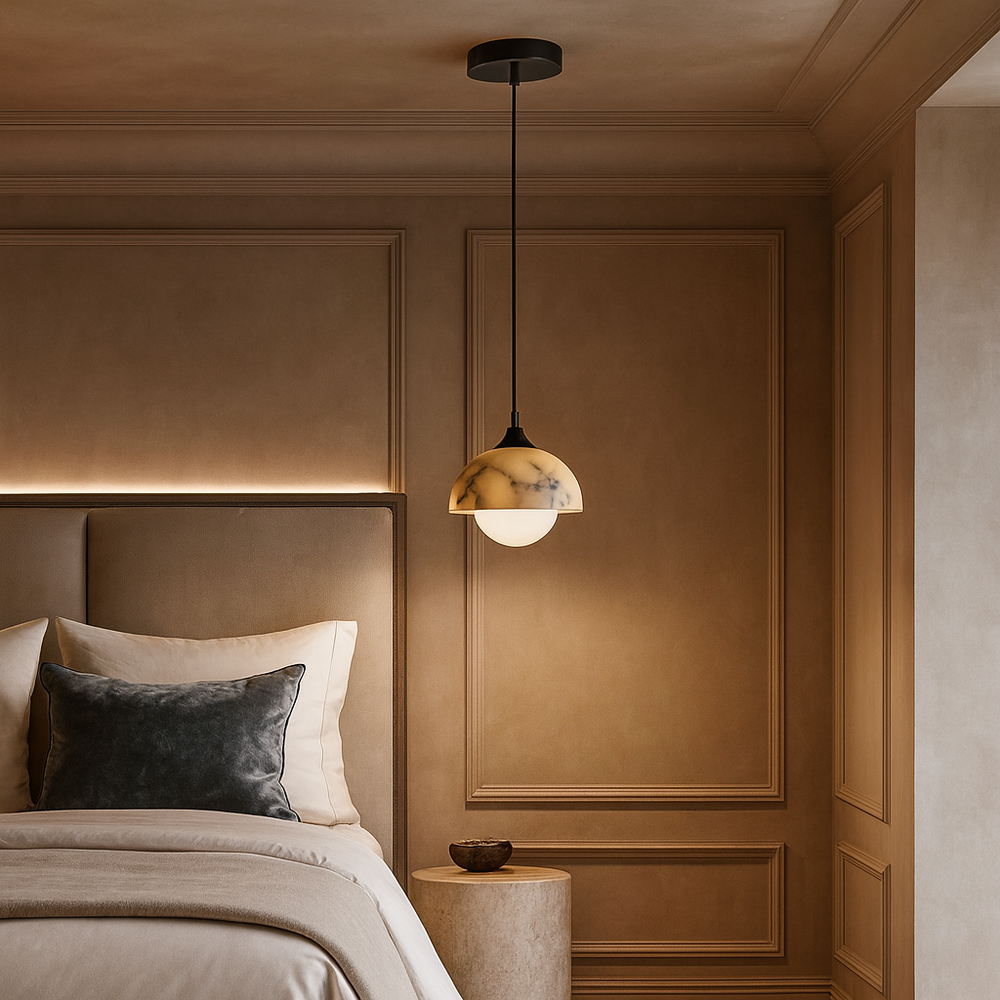 A modern bedroom with beige walls, a tufted headboard, and soft bedding features the Morsale Aeris Natural Marble Pendant Light above a small round side table with a bowl, adding warmth and elegance with its contemporary design.