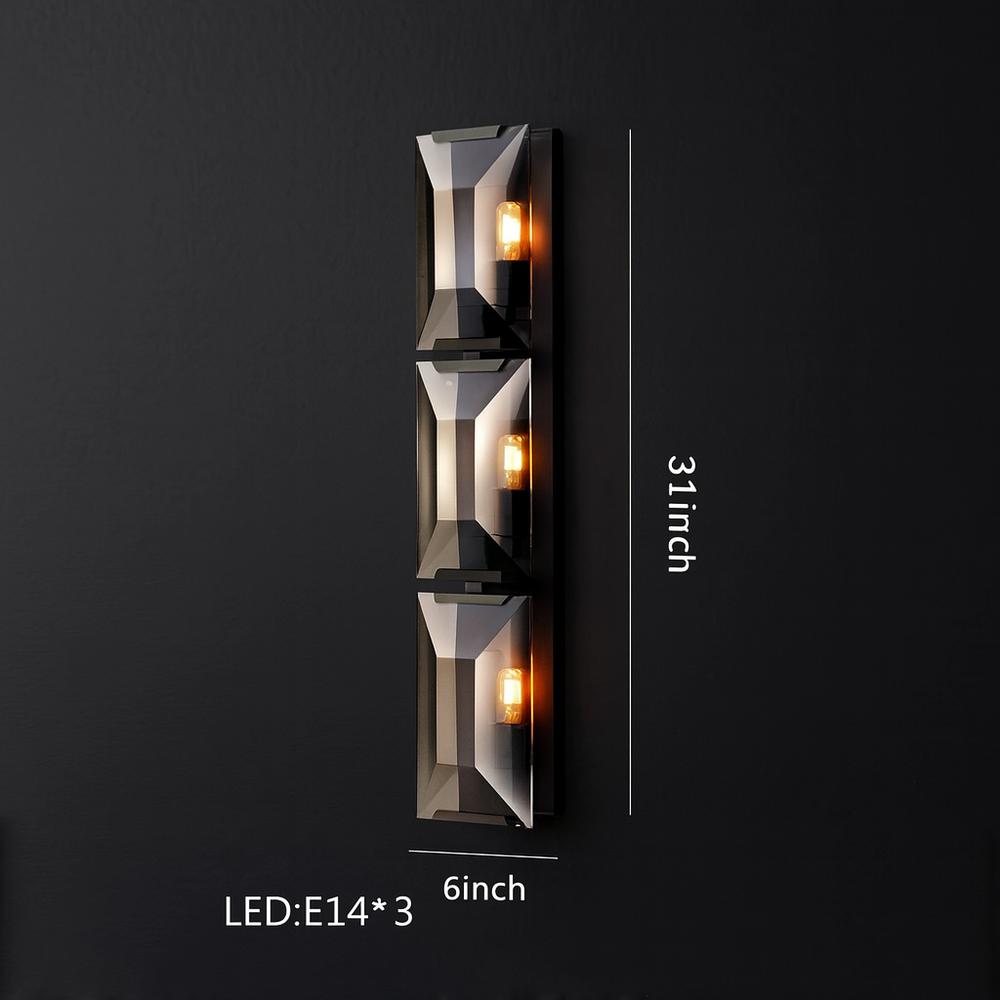 
                  
                    The Villano Crystal Wall Sconce by Morsale.com features a modern black design with three E14 LEDs in a vertical row (31"H x 6"W), creating ambient light and a sleek, sophisticated look on dark walls.
                  
                
