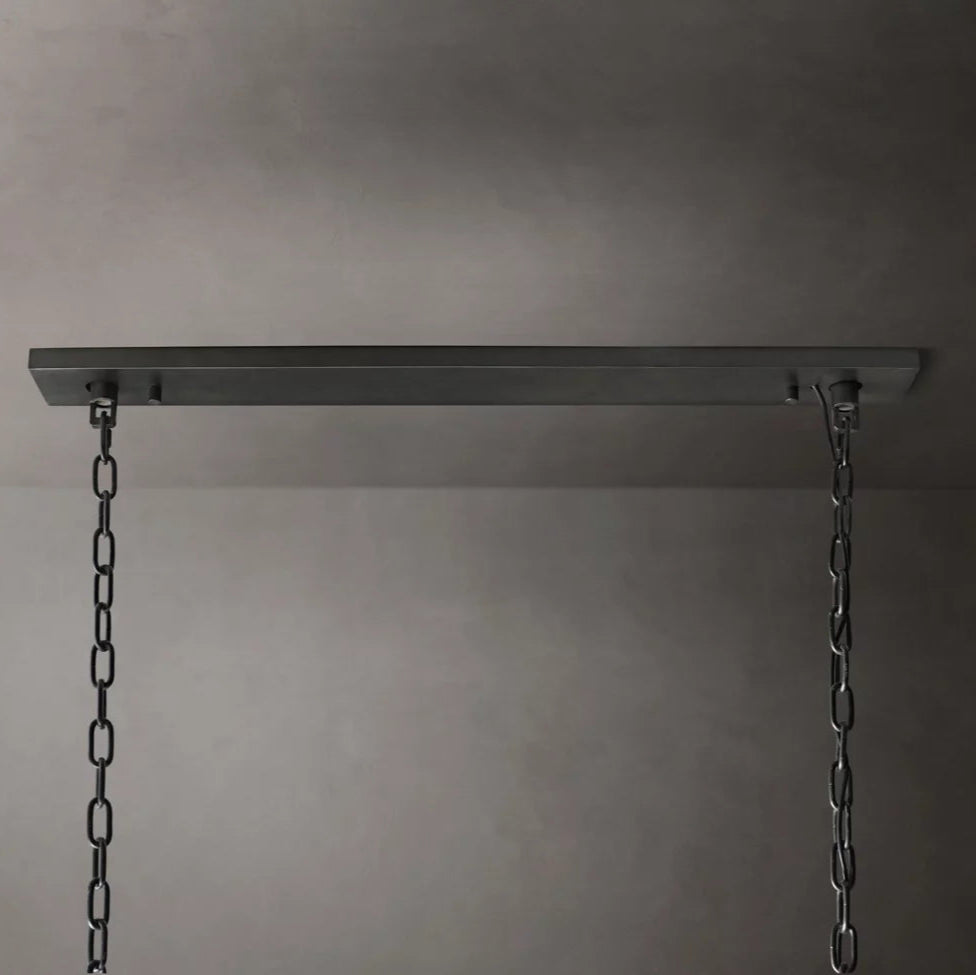 
                  
                    A close-up view of the Brookhill Crystal Rectangular Chandelier by Morsale.com shows it suspended from a rectangular metal ceiling plate with two chains against a plain gray background.
                  
                